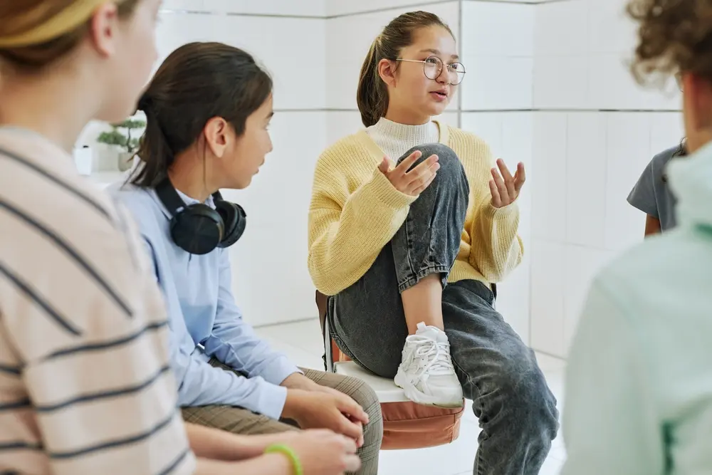 Portrait Of Teenage Girl Sharing Feelings In Support Group Circle