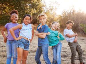 5 kids outside in an article on adhd and friendship.