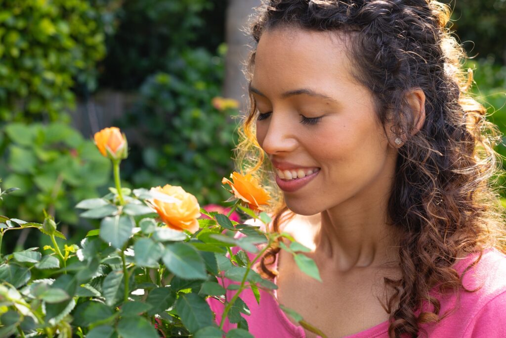 Woman smelling flowers in an article on inner-voice and resilience.