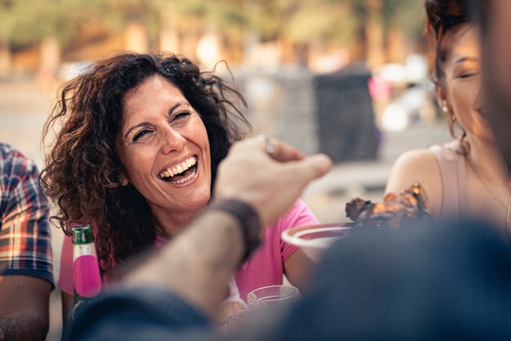 ABeautifulMatureWomanWithCurlyHairHasAGenuine - Caroline Maguire, M.Ed. | Social Skills For Kids & Adults